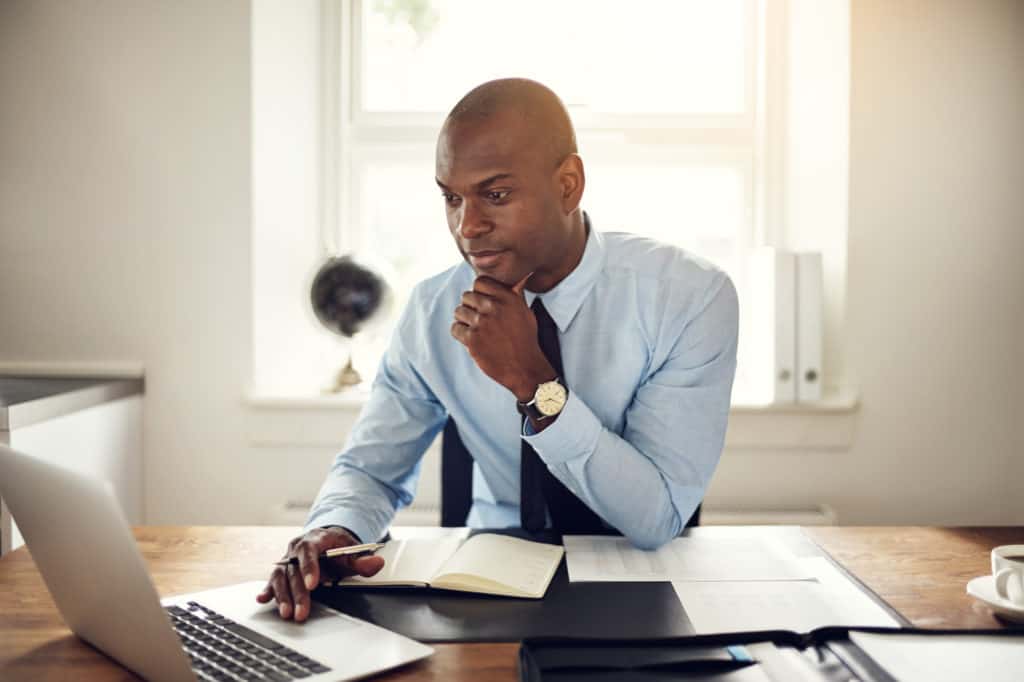 Young businessman working on a laptop in an office